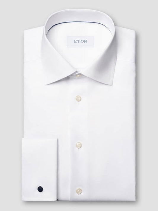 A neatly folded Eton Slim Fit White French Cuff Dress Shirt features a classic collar, buttoned front, and a visible “ETON” label inside the collar, highlighting its wrinkle-free quality and elegant French cuffs.