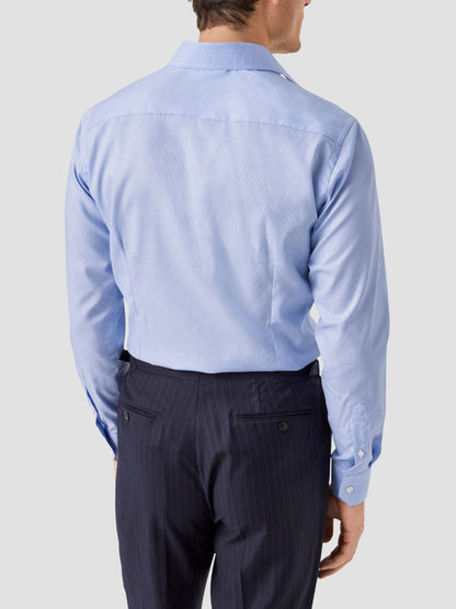 A man is shown from the back wearing an Eton Contemporary Fit Light Blue Houndstooth Dress Shirt with dark pinstripe trousers against a plain background.