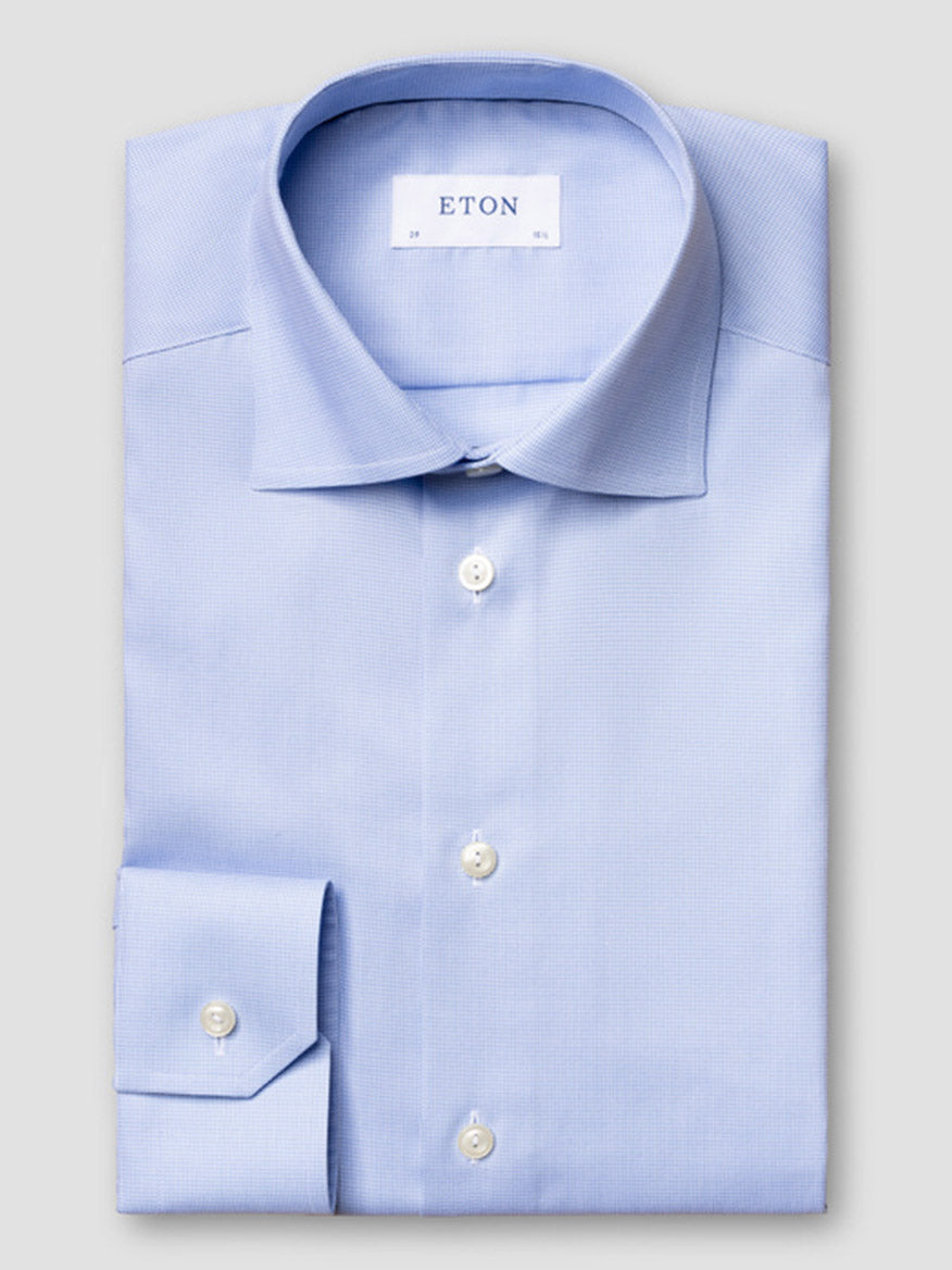 A light blue Eton Contemporary Fit Houndstooth Dress Shirt with white buttons, neatly folded on a plain gray surface. The "ETON" label is visible inside the collar.