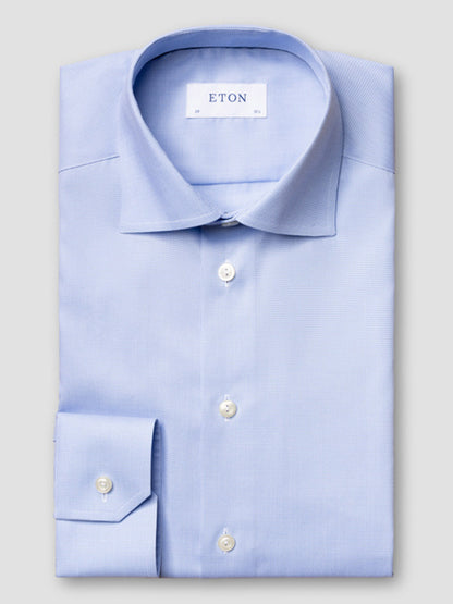 A light blue Eton Contemporary Fit Houndstooth Dress Shirt with white buttons, neatly folded on a plain gray surface. The "ETON" label is visible inside the collar.