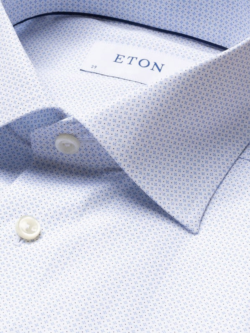 Close-up of the Eton Slim Fit Geometric Print Poplin Dress Shirt in Sky Blue, featuring white buttons and a cutaway collar with the Eton label inside.