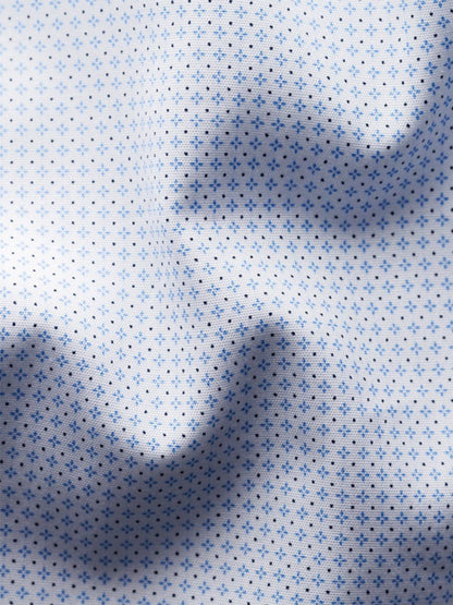 Close-up of the Eton Slim Fit Geometric Print Poplin Dress Shirt in Sky Blue, showing white fabric with a small blue dotted pattern, soft folds, and shadows.