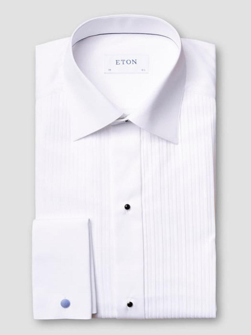A neatly folded Eton Contemporary Fit Plissé Black Tie Dress Shirt in white features a pleated front, black stud buttons, French cuffs, and an "ETON" label on the inner collar.