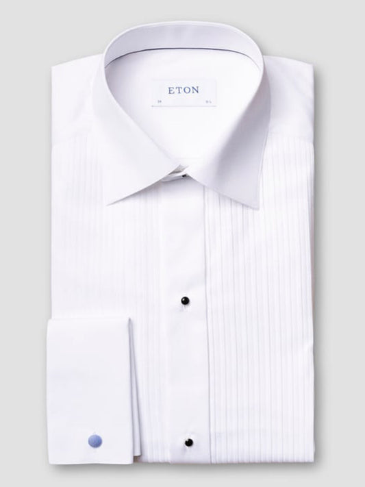 A neatly folded Eton Contemporary Fit Plissé Black Tie Dress Shirt in white features a pleated front, black stud buttons, French cuffs, and an "ETON" label on the inner collar.