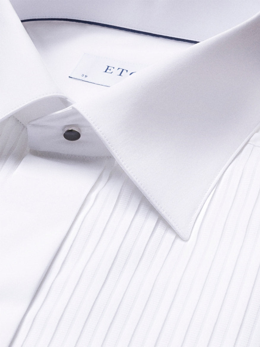 Close-up of the Eton Slim Fit Plissé Bib-Front Tuxedo Shirt in White, showcasing its pleated front, spread collar, and metallic stud buttons—ideal for black-tie events.