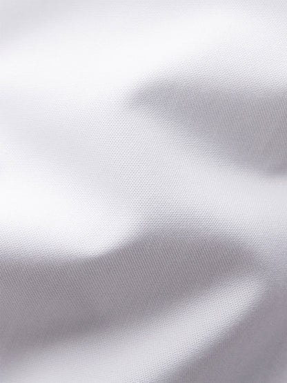 Close-up of the Eton Slim Fit Plissé Bib-Front Tuxedo Shirt in White, showing its textured pleated front fabric and soft folds.