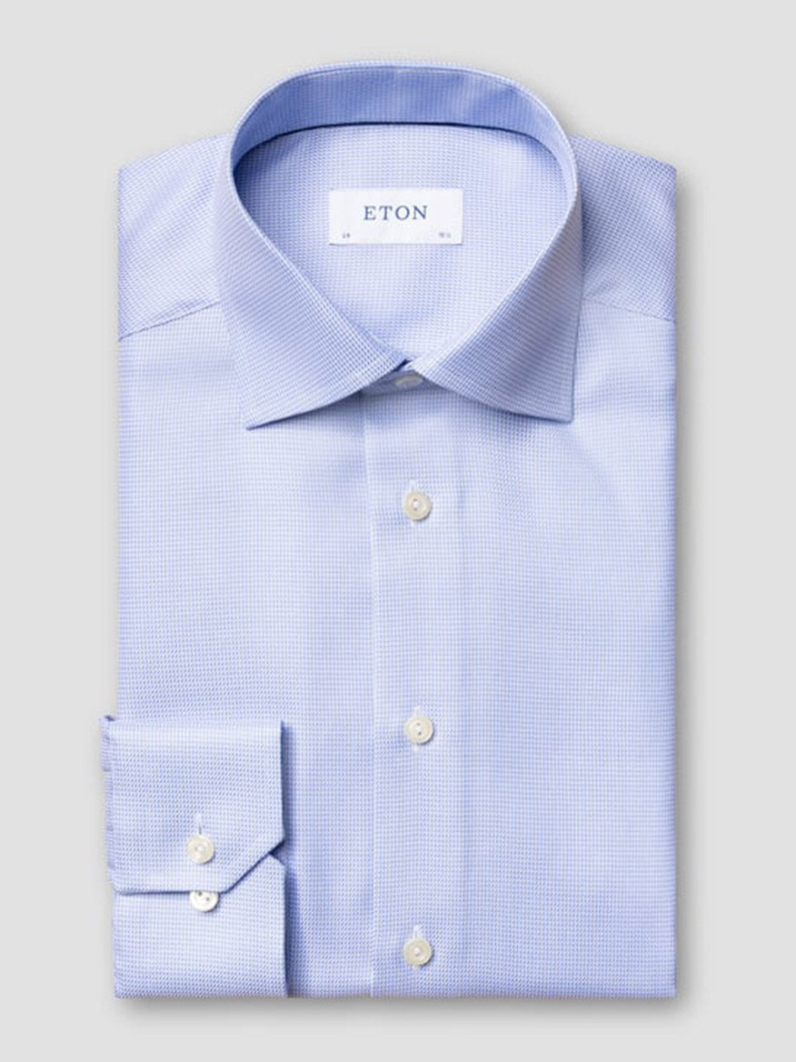 The Eton Contemporary Fit Semi Solid Dobby Dress Shirt in Light Blue features a textured fabric, spread collar, white buttons, and the "ETON" brand label inside the collar.