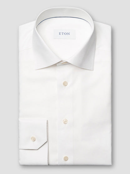 The Eton Contemporary Fit Semi Solid Dress Shirt in White features a neatly folded design with a pointed collar, buttoned cuffs, and the "ETON" label visible inside the collar.