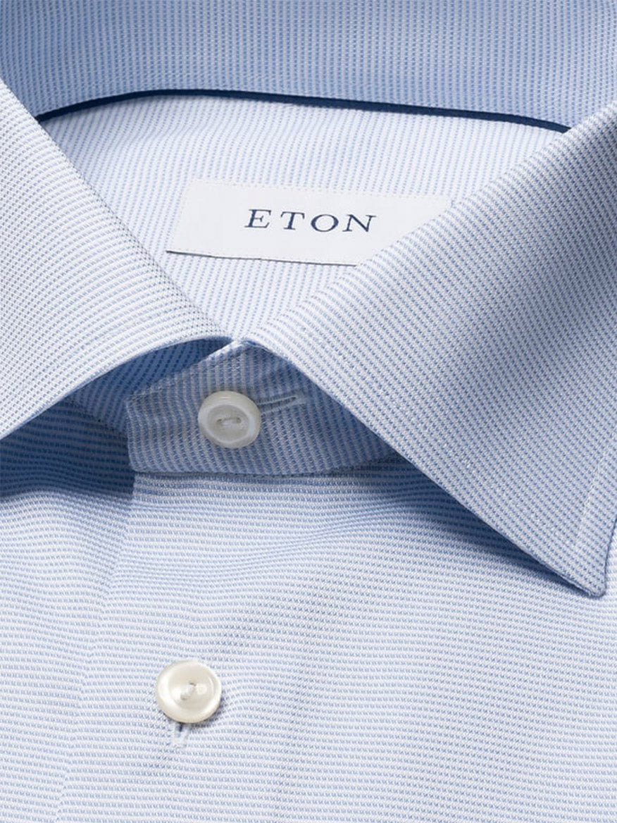 Close-up of the Eton Contemporary Fit Semi Solid Dress Shirt in Light Blue, showcasing its spread collar, white buttons, and a subtle textured pattern.