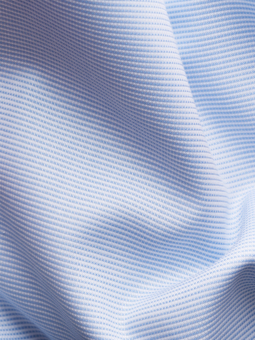 Close-up of the Eton Contemporary Fit Semi Solid Dress Shirt in light blue, showcasing its textured fabric with a small grid pattern, visible folds, and shadows.