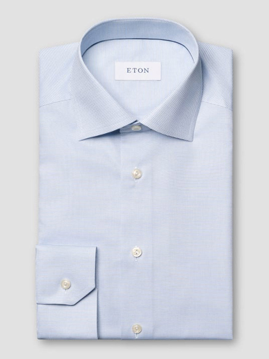 The Eton Contemporary Fit Semi Solid Dress Shirt in Light Blue features a pointed collar, white buttons, and a neatly folded design with the "ETON" label inside the collar.