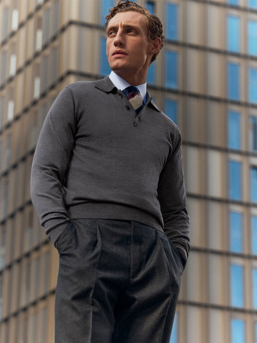 A man wearing the Eton Slim Fit Semi Solid Dress Shirt in light blue with a cut away collar stands outdoors, hands in his pockets, in front of a modern glass building.
