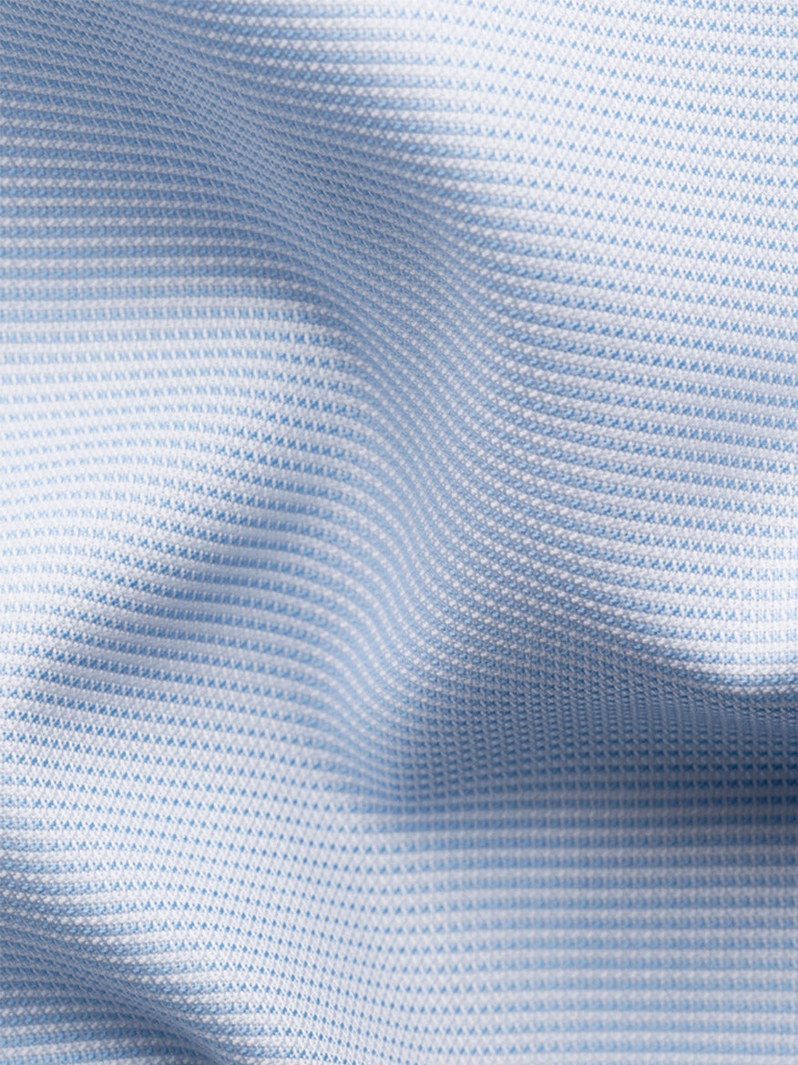Close-up of the Eton Slim Fit Semi Solid Dress Shirt in Light Blue, featuring textured fabric with a subtle grid pattern and visible folds, perfect for a wrinkle-free finish and an extreme cut away collar.