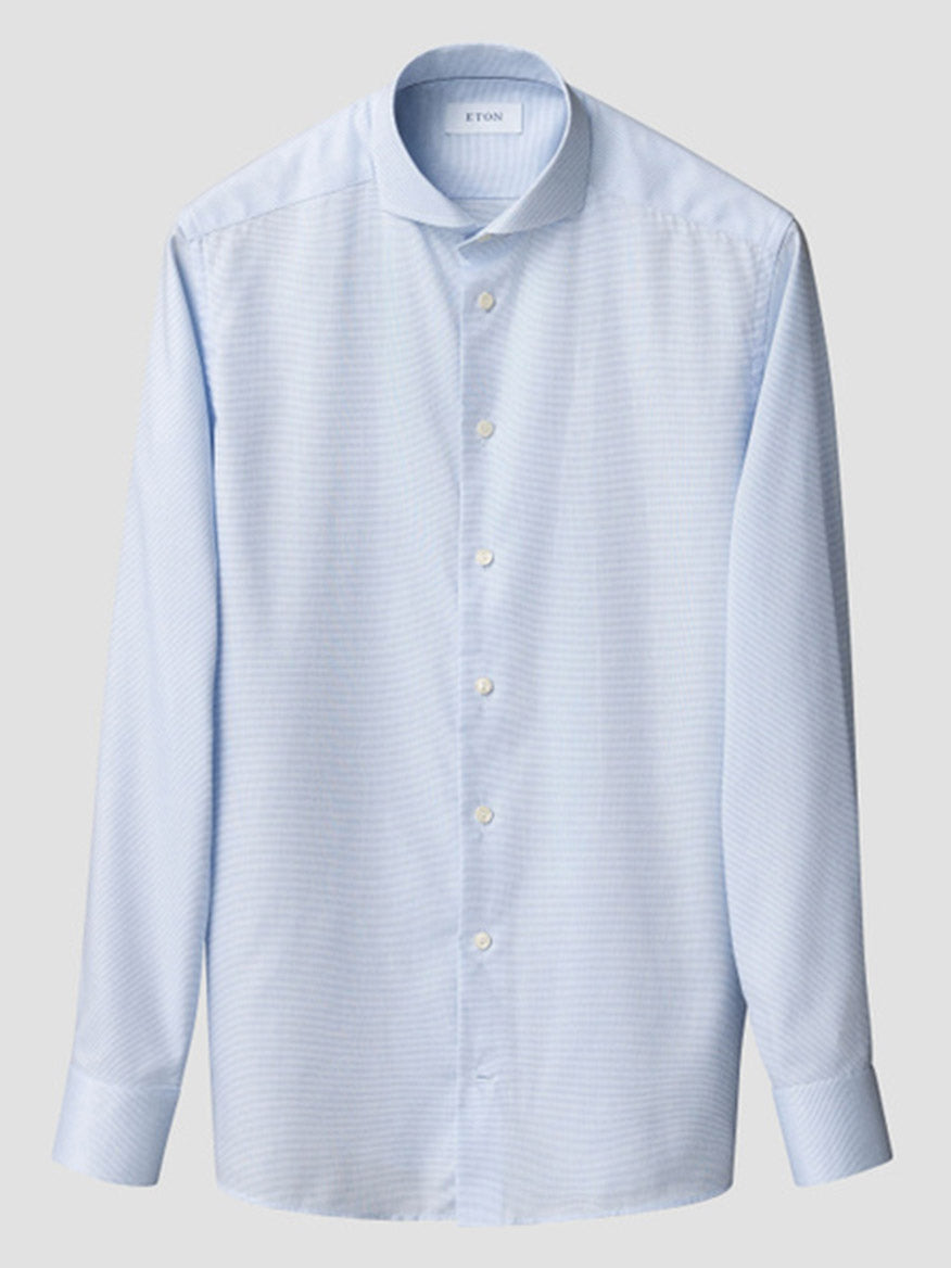 Eton Slim Fit Semi Solid Dress Shirt in Light Blue with extreme cut away collar and white buttons, featuring long sleeves. Subtle semi-solid pattern visible, displayed on a plain background.
