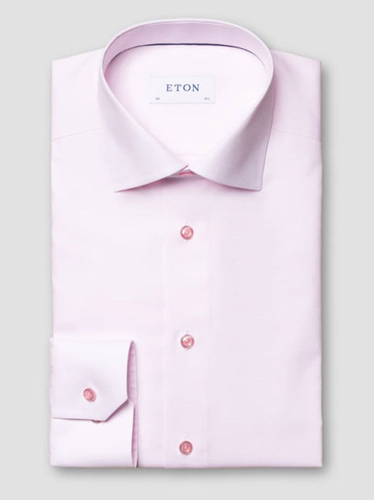 A neatly folded Eton Contemporary Fit Semi Solid Piping Details Dress Shirt in pink, long-sleeve and button-up, features a spread collar with a visible "ETON" label on the inside collar.