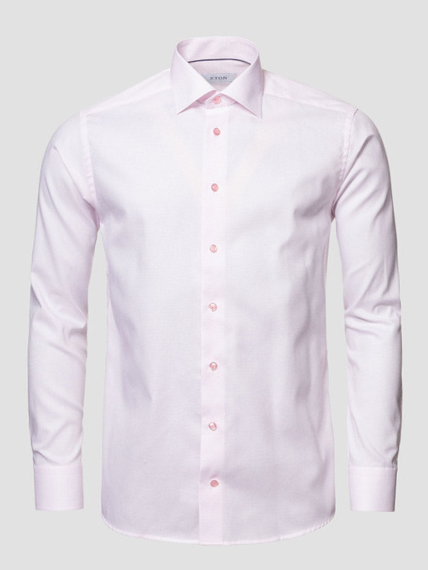 The Eton Slim Fit Semi Solid Piping Details Shirt in Pink features long sleeves, a cut away collar, button-up front, and light pink piping details, shown on a neutral background.
