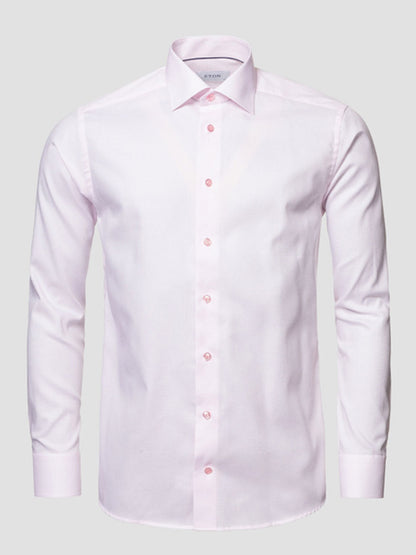 The Eton Slim Fit Semi Solid Piping Details Shirt in Pink features long sleeves, a cut away collar, button-up front, and light pink piping details, shown on a neutral background.