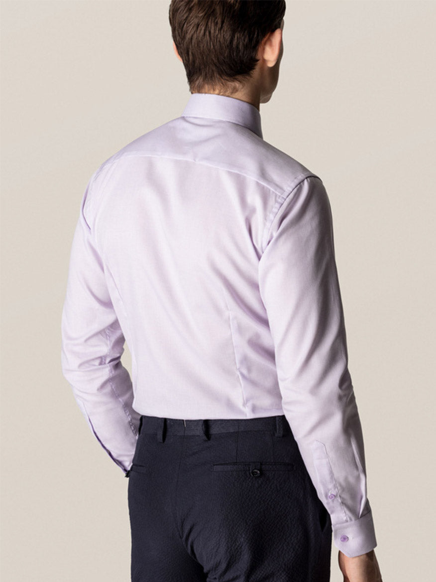 A man is seen from the back wearing the Eton Slim Fit Semi Solid Piping Details Shirt in Light Purple with dark pants against a plain background.