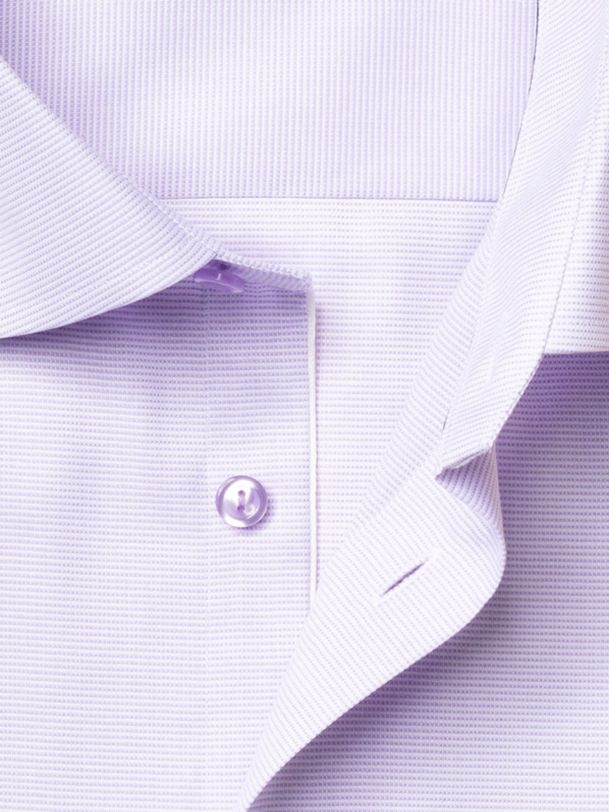 Close-up of the Eton Slim Fit Semi Solid Piping Details Shirt in light purple, featuring a cutaway collar, button, part of the placket, and a subtle textured pattern.