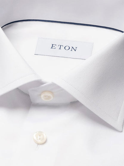 Close-up of the Eton Contemporary Fit White Signature Twill Dress Shirt with a pointed collar and visible brand label—ideal as a versatile, wrinkle-free option for any business meeting.