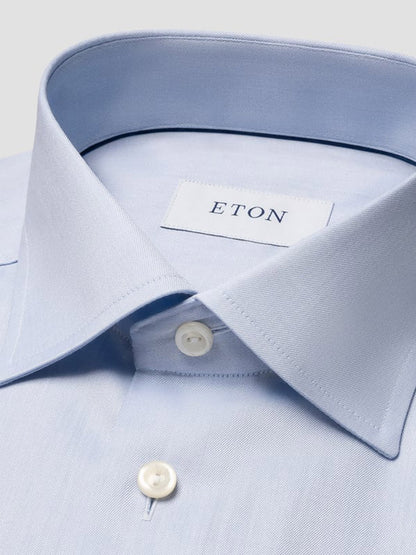 Close-up of the Eton Contemporary Fit Light Blue Signature Twill Dress Shirt, featuring white buttons and an inner collar label reading "ETON.