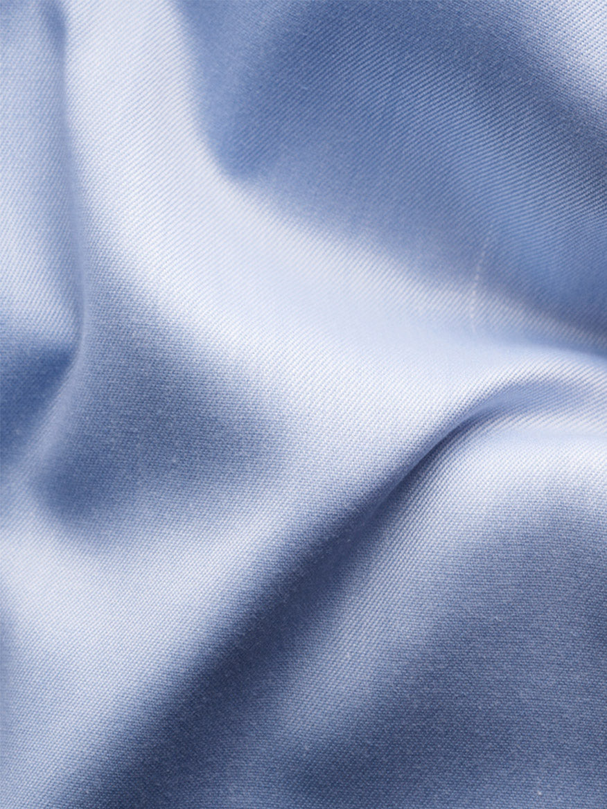 Close-up of light blue satin fabric with soft folds and a shiny texture, echoing the buttery feel of the Eton Contemporary Fit Signature Twill Dress Shirt in Light Blue with Navy Details.