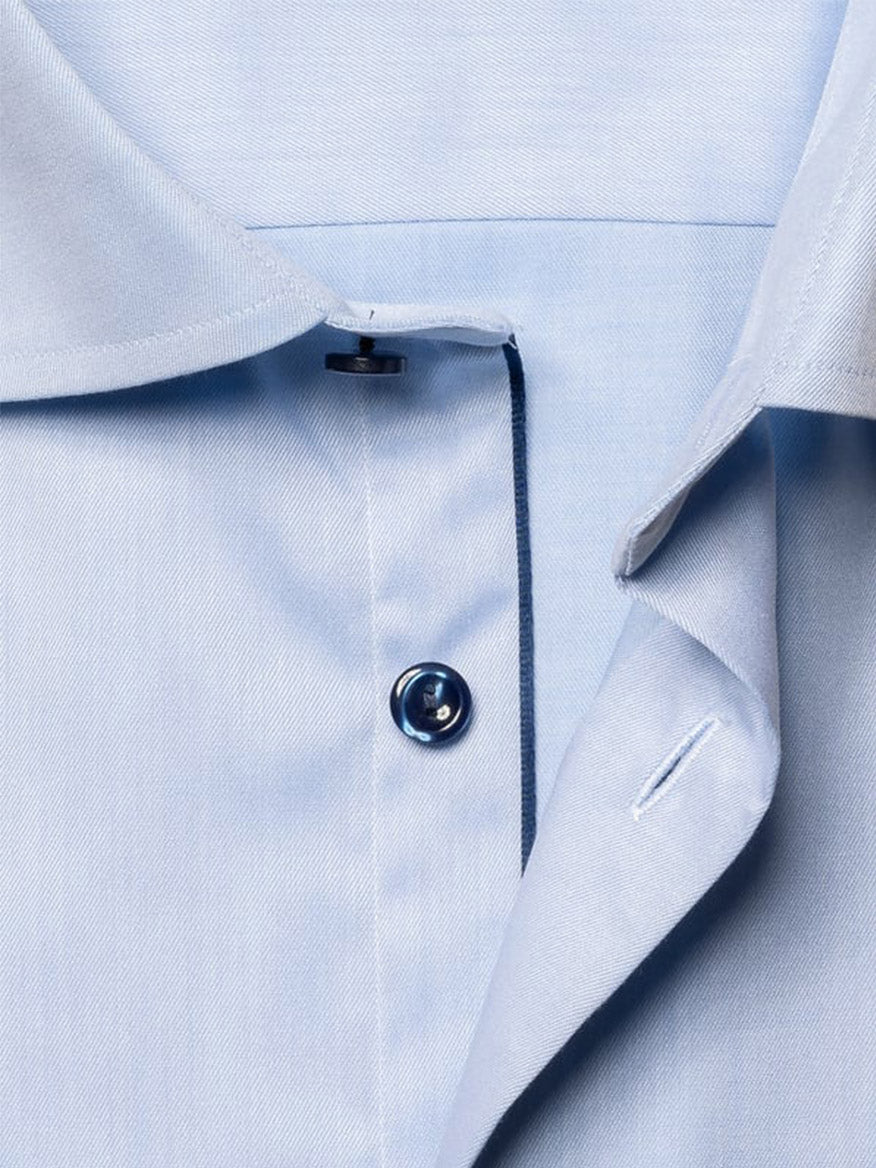 Close-up of the Eton Contemporary Fit Signature Twill Dress Shirt in light blue with navy details, highlighting the button, buttonhole, collar, and placket.