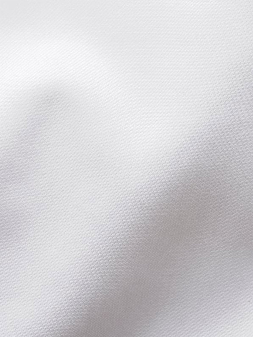 Close-up of white Signature Twill fabric with a subtle diagonal weave, featuring slight folds, as seen on the Eton Slim Fit Solid Signature Twill Dress Shirt in White – Single Cuff.