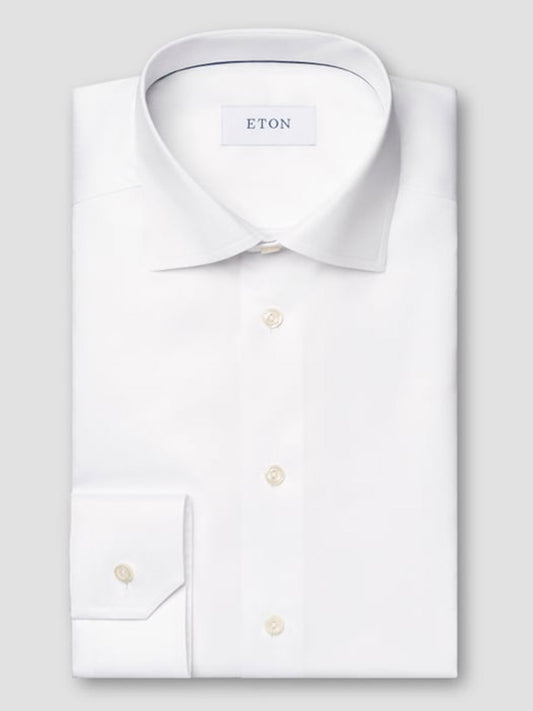The Eton Slim Fit White Signature Twill Dress Shirt features a spread collar, buttoned cuffs, and visible brand label, crafted from organic cotton for outstanding comfort and style.