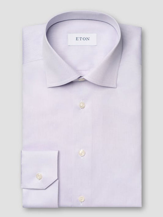 The Eton Slim Fit Purple Signature Twill Dress Shirt features a neatly folded design, spread collar, white buttons, and offers a sharp slim fit.