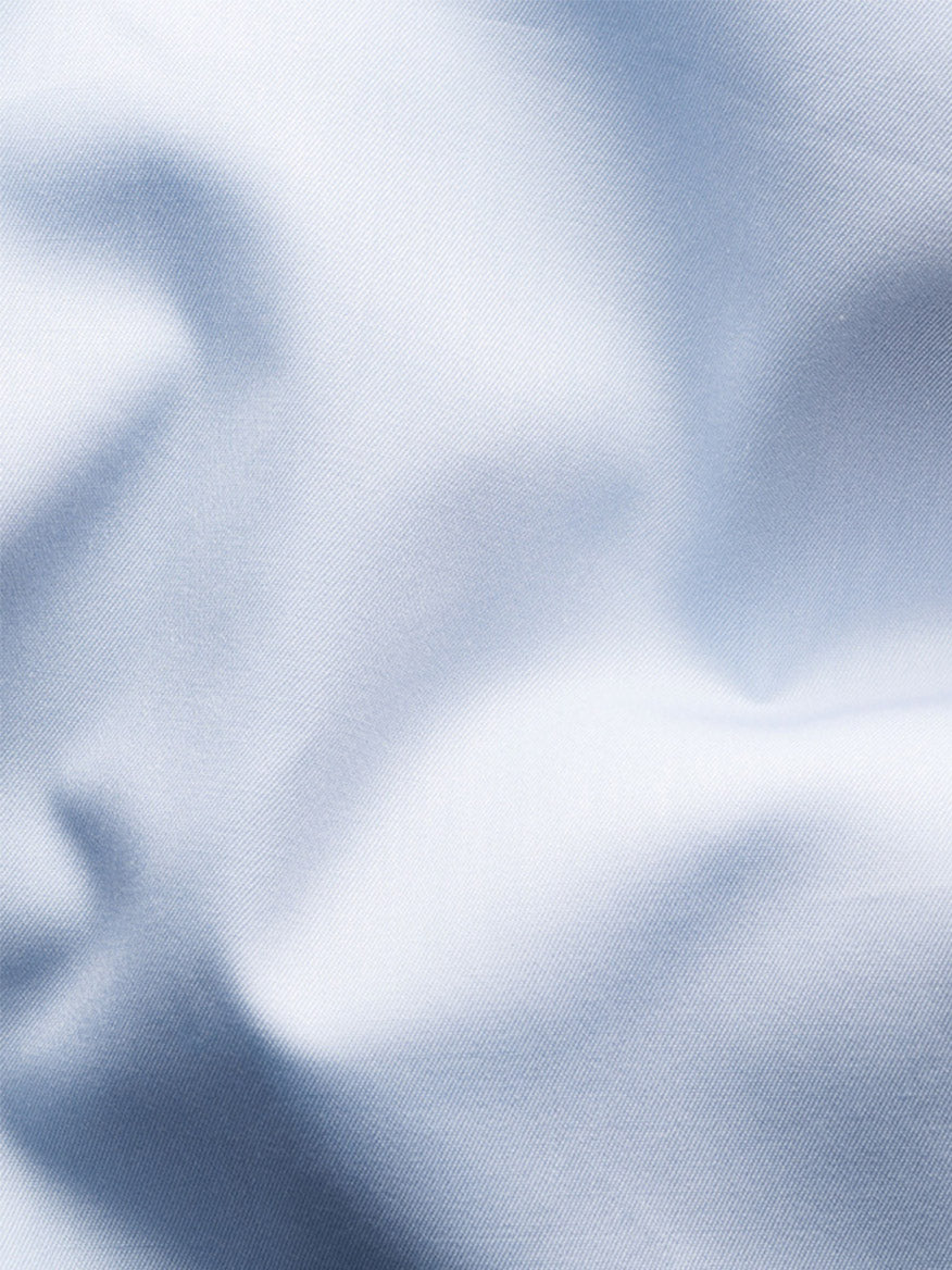 Close-up of light blue fabric with gentle folds and a smooth, subtly lustrous texture, highlighting the elegance of the Eton Contemporary Fit Solid Elevated Twill Dress Shirt in Light Blue.