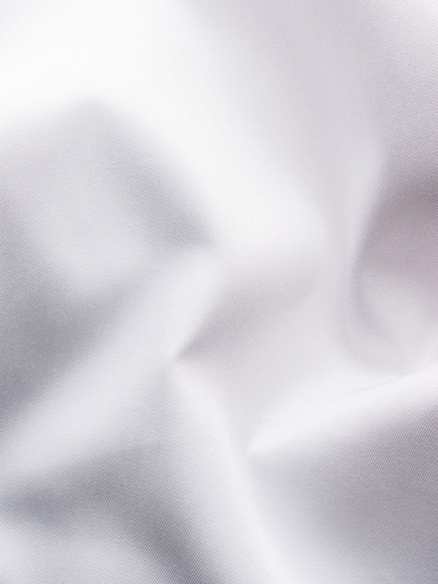 Close-up of the Eton Slim Fit Solid Elevated Twill Dress Shirt in White, featuring smooth, crease-resistant fabric with soft folds—ideal for a premium dress shirt.