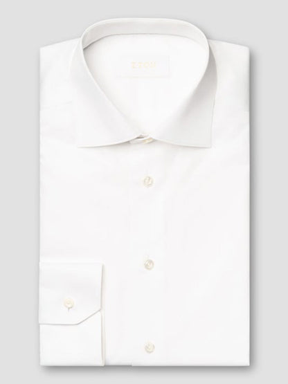The Eton Slim Fit Solid Elevated Twill Dress Shirt in White, made from premium fabric with a classic collar and buttoned cuffs, is neatly folded and displayed against a light gray background.