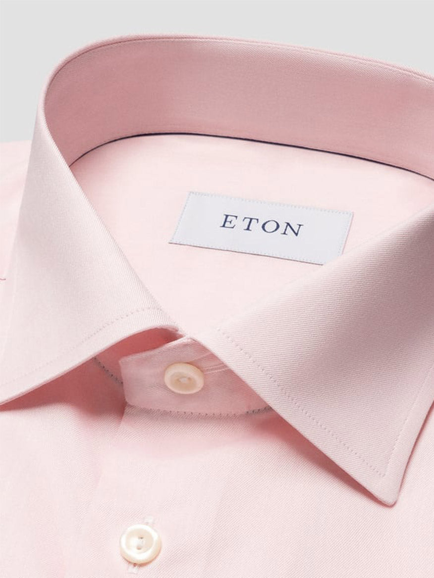 Close-up of the Eton Contemporary Fit Solid Signature Twill Dress Shirt in pink, featuring white buttons and a visible "ETON" brand label on the collar.