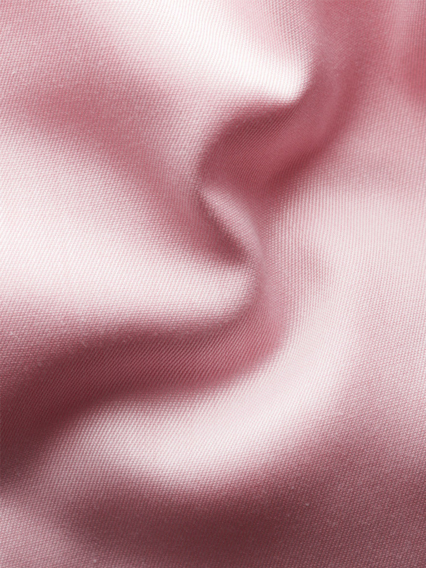 Close-up of light pink, smooth satin fabric with soft folds and gentle shadows, evoking the luxurious texture of the Eton Contemporary Fit Solid Signature Twill Dress Shirt in Pink.