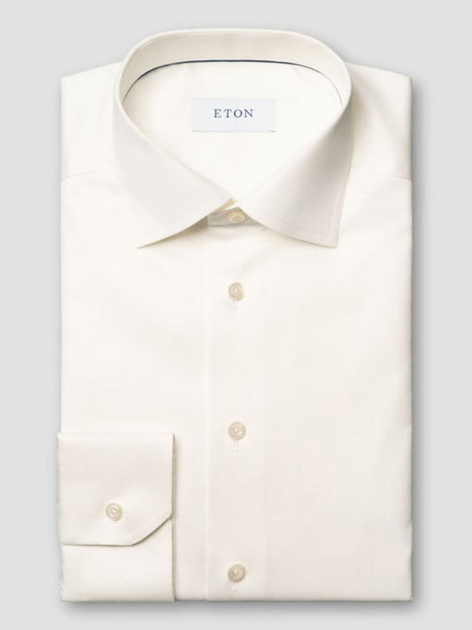 The Eton Slim Fit Solid Signature Twill Dress Shirt in Off-White features long sleeves, a spread collar, button cuffs, organic cotton construction, and the Eton label inside the collar.
