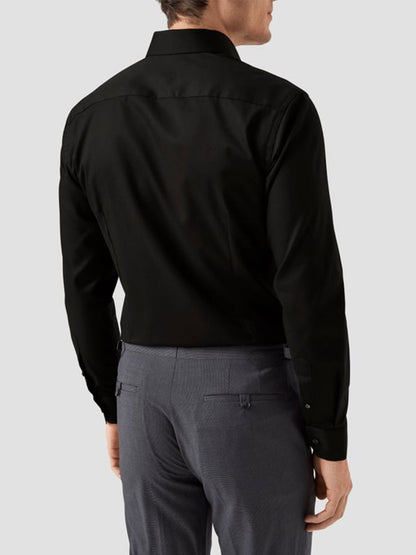 A man is seen from the back wearing an Eton Slim Fit Solid Signature Twill Dress Shirt in black with a cut away collar, paired with gray dress pants, against a light gray background.