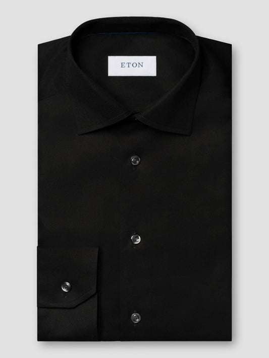 The Eton Slim Fit Solid Signature Twill Dress Shirt in Black features a cut away collar, black buttons, and premium organic Supima cotton for comfort and style. Brand label inside; tailored slim fit and crease-resistant.