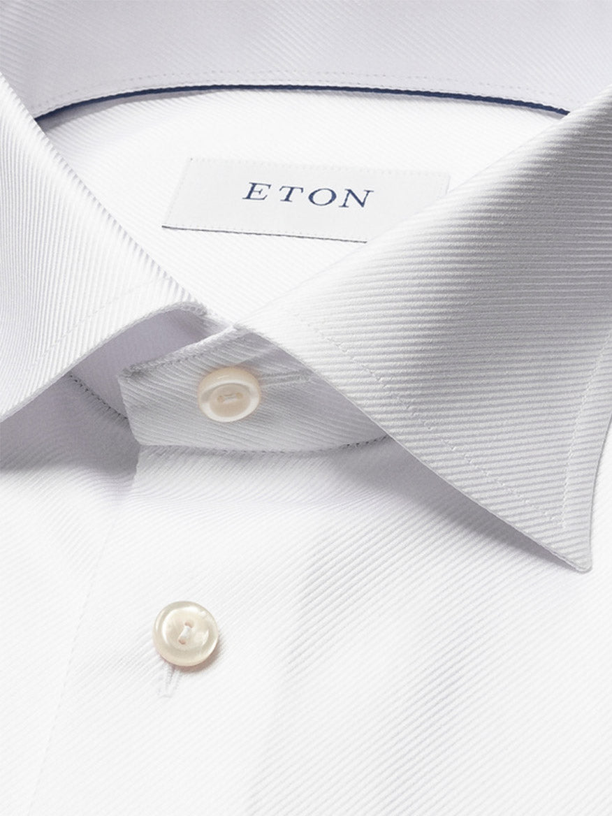Close-up of the Eton Contemporary Fit Solid Textured Twill Dress Shirt in White, showcasing its pointed collar, French cuffs, white buttons, and signature Eton label.
