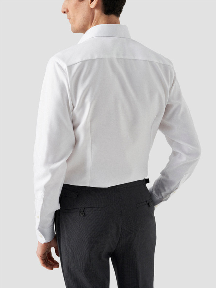 A man is shown from the back wearing the Eton Contemporary Fit Solid Textured Twill Dress Shirt in White with dark dress pants, set against a plain light background.