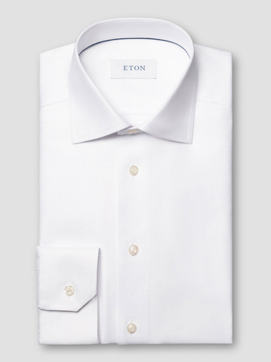 A folded white Eton Contemporary Fit Solid Textured Twill Dress Shirt with a classic collar and single cuff, featuring an "ETON" label on the inside collar.