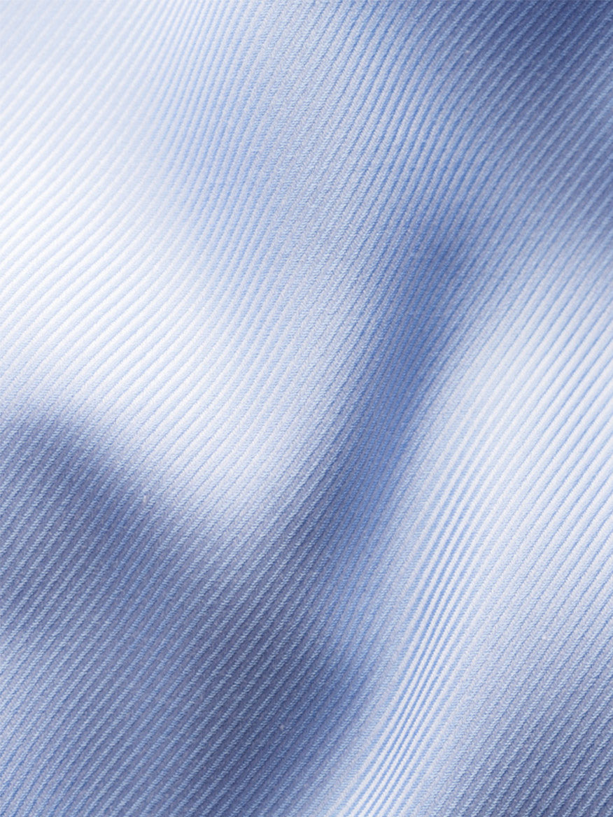 Close-up of the Eton Contemporary Fit Solid Textured Twill Dress Shirt in Light Blue, highlighting the organic cotton fabric’s diagonal ribbed texture, soft folds, and subtle shadows across the surface.