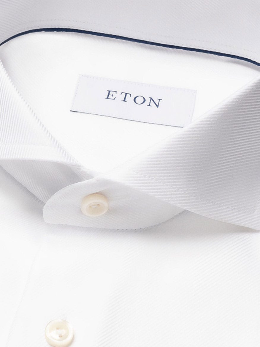 Close-up of the Eton Slim Fit Solid Textured Twill Dress Shirt in White featuring an extreme cut away collar, visible buttons, and an "ETON" label—an ideal choice for business attire.
