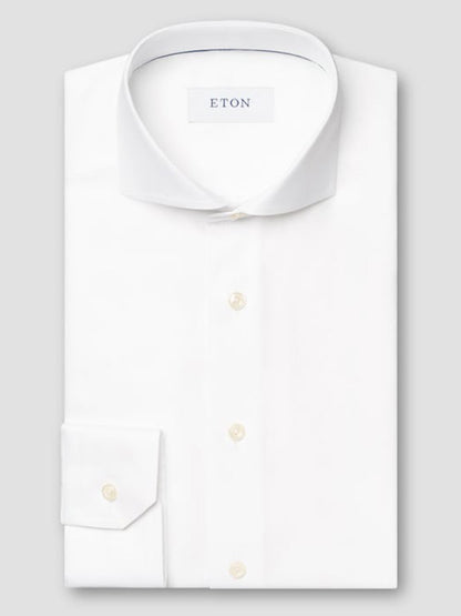 The Eton Slim Fit Solid Textured Twill Dress Shirt in White features an extreme cut away collar, shown neatly folded on a light gray background—ideal for a sharp, modern business look.