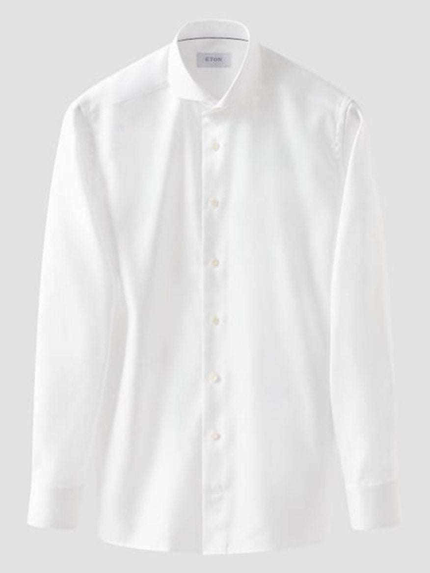 The Eton Slim Fit Solid Textured Twill Dress Shirt in White features an extreme cut away collar and button-down front, ideal for business attire, shown against a plain light gray background.