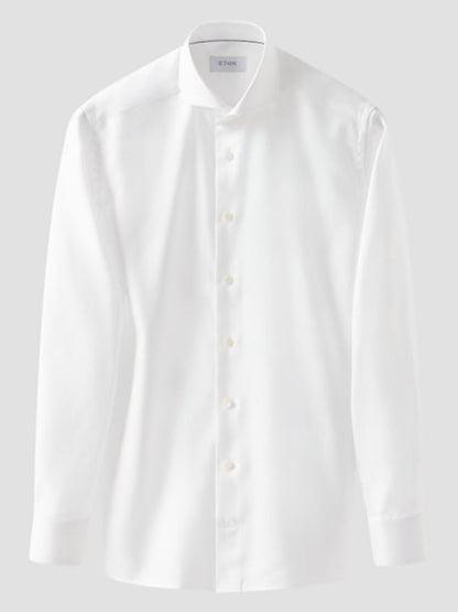 The Eton Slim Fit Solid Textured Twill Dress Shirt in White features an extreme cut away collar and button-down front, ideal for business attire, shown against a plain light gray background.