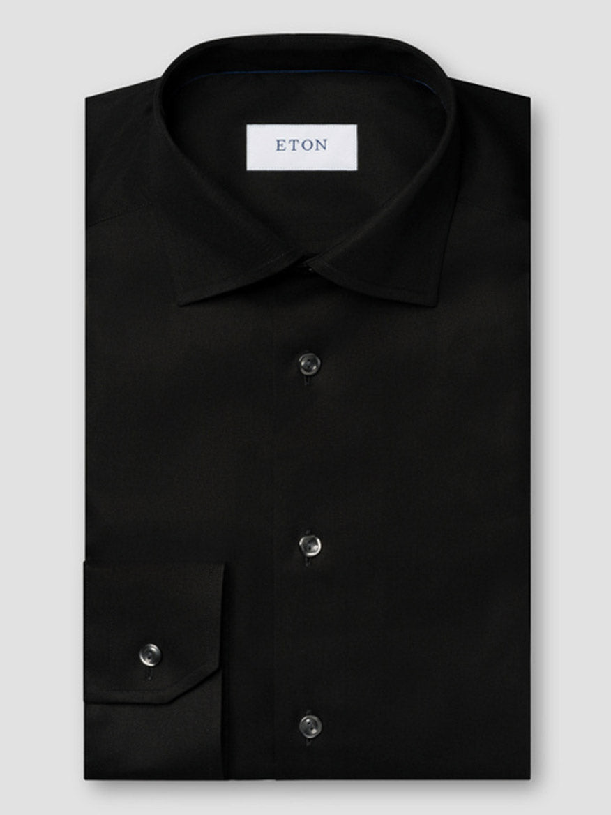 The Eton Contemporary Fit Black Signature Twill Dress Shirt features a spread collar, buttoned cuffs, and a white "ETON" label inside the collar. This wrinkle-free shirt offers style and convenience for modern professionals.