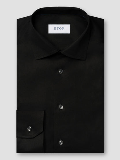 The Eton Contemporary Fit Solid Textured Twill Dress Shirt in Black features a classic collar, button front, structured texture, and visible brand label—ideal for sharp business attire.