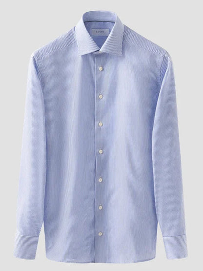 Eton Contemporary Fit Striped Fine Twill Dress Shirt in Light Blue, featuring long sleeves, thin white vertical stripes, white buttons, and a classic collar, shown on a plain light gray background.
