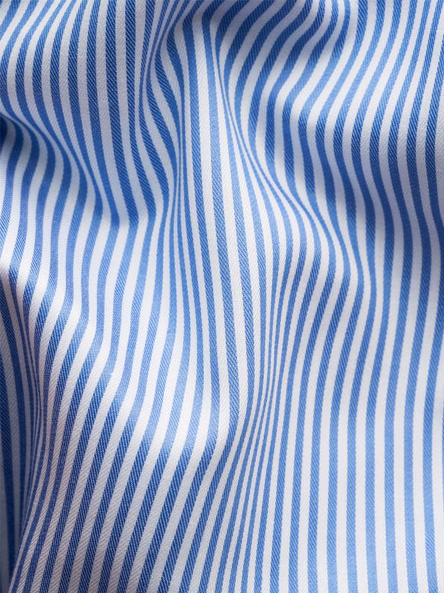 Close-up of the Eton Slim Fit Striped Fine Twill Dress Shirt in Mid Blue, featuring an extreme cut away collar and soft blue and white bengal stripes with gentle folds.